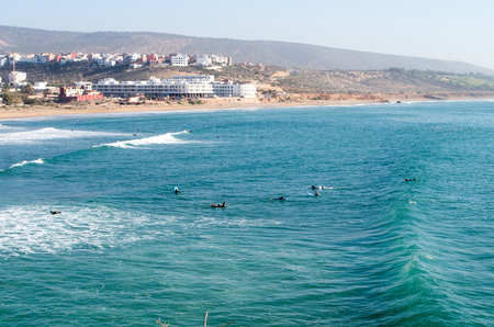 Surfers paddling back after wave at surf spot called Banana Point in Morocco, January 2018.の写真素材