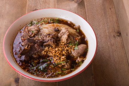 close up bowl of noodle soup wiht stewed pork
