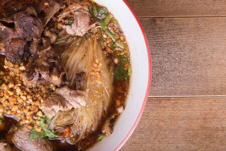 close up bowl of noodle soup wiht stewed pork