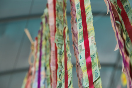 Thai bank note decoration hanging on sling for Religious ceremony of Buddhism temple selective soft...