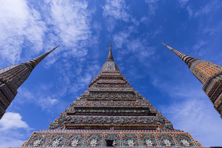 Three pinnacle of pagada in temple of thaland on blue sky and clound backgroundの写真素材