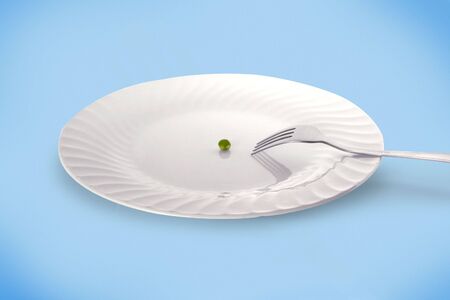 Dish with fork and a peaの写真素材