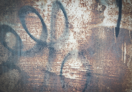 old metal wall garage stains, rust, peeling paint Grand graffiti in black paint