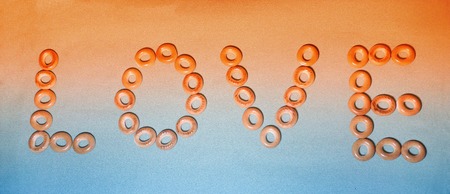 word love laid out the crackers on the orange-blue backgroundの写真素材