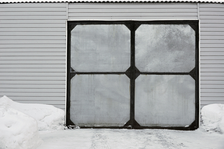 garage with metal gates in winterの写真素材