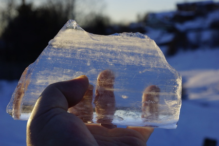 Icicle in his hands. shines on the sun. ice floe melts from the sun
