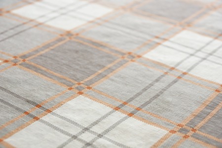tablecloth in a large cage on the table texture backgroundの写真素材