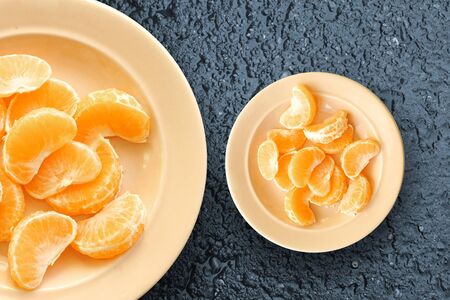 orange slices in cloudy weather. orange slices on a plate with a background of raw asphaltの写真素材
