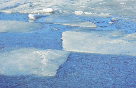 large pieces of ice are white.ice drift on the river. large ice floes floating on the water. spring...