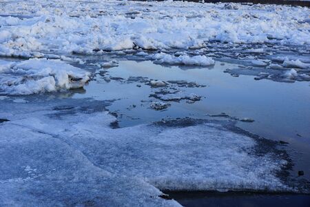 large pieces of ice are white.ice drift on the river. large ice floes floating on the water. spring...