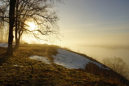 morning spring fog over the river rises the sun is melting snow beautiful sceneryの写真素材