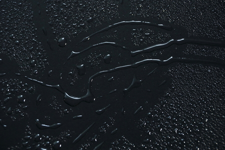 water drops on black background abstract texture backgroundの写真素材