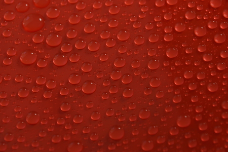 water drops on red background textureの写真素材