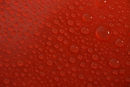 water drops on red background textureの写真素材