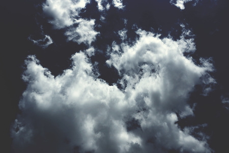 clouds are cumulonimbus white on a dark background fluffy bizarre shapeの写真素材