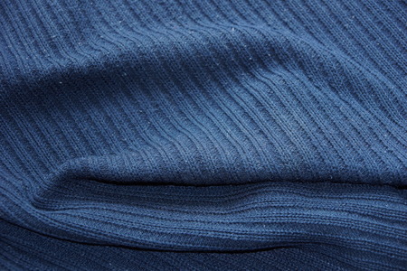 warm blue dark woolen sweater fabric texture background wool close-up. season winter autumn spring