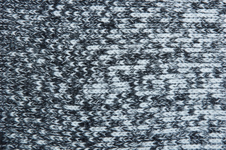 warm gray light dark gradient woolen sweater fabric texture background wool close-up. season winter...