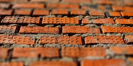 surface of an old red brick wall grunge background texture close upの写真素材