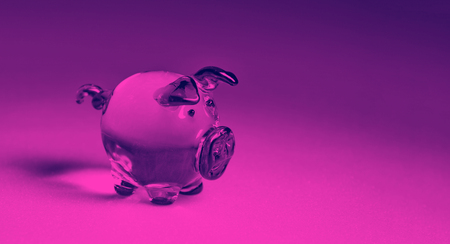 year of pig glass pig on purple pink background close-upの写真素材
