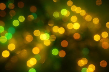 natural bokeh holiday lights background for design green yellow