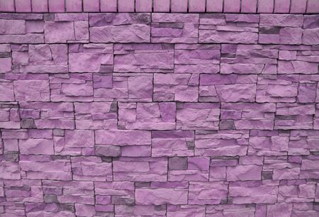 Facing tile stone wall texture pink background. modern facing material. artificial stone gypsumの写真素材