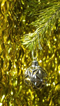 Christmas background. Silver Christmas ball on gold glitter background. Happy new year gold colorの写真素材