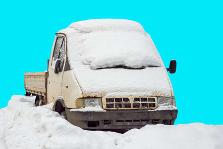 old pickup truck in the snow. the car is isolated on a blue background. can be used for the snow apocalypseの写真素材