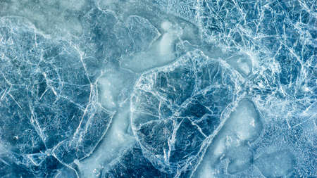 Beautiful ice texture with cracks of a frozen puddle on the asphalt for 3d texturing or design....