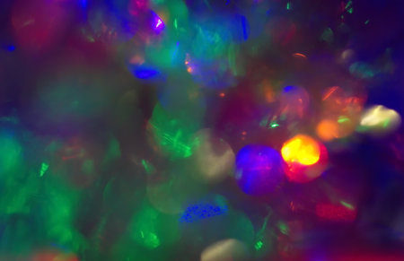 christmas bokeh garlands of lights, bright lens effect light spots blurred dark background overlay