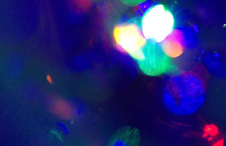 christmas bokeh garlands of lights, bright lens effect light spots blurred dark background overlay