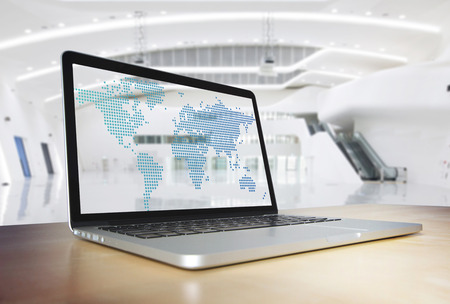 Transparent computer screen with world map dots on the wooden desk interior office concept