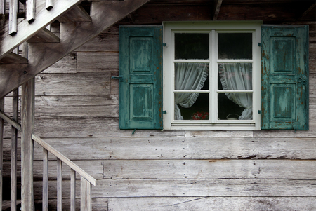 Old wooden house with retro stairs and vintage window.の写真素材