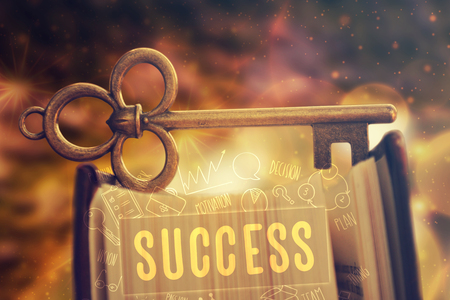 Old key standing on the book. Motivational concept, success background.の写真素材