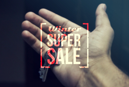 Real Estate Agent holding keys for winter sale.の写真素材