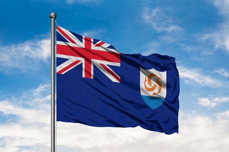Flag of Anguilla waving in the wind against white cloudy blue sky.の写真素材