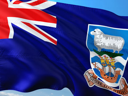 Flag of Falkland Islands waving in the wind against deep blue sky. High quality fabric.の写真素材