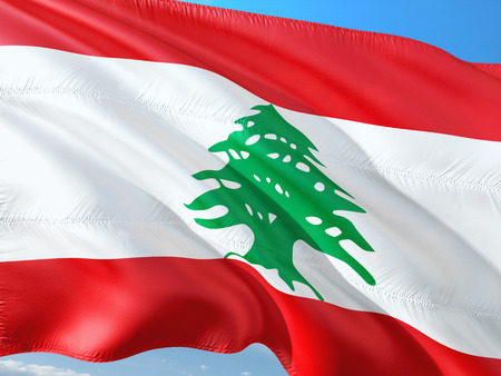 Flag of Lebanon waving in the wind against deep blue sky. High quality fabric.の写真素材