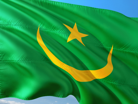 Flag of Mauritania waving in the wind against deep blue sky. High quality fabric.の写真素材