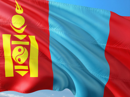 Flag of Mongolia waving in the wind against deep blue sky. High quality fabric.の写真素材