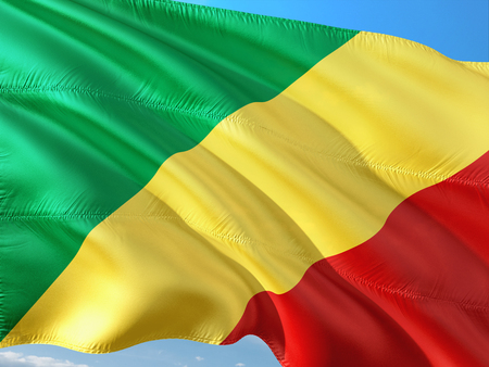 Flag of Republic Of Congo waving in the wind against deep blue sky. High quality fabric.の写真素材