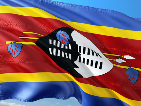 Flag of Swaziland waving in the wind against deep blue sky. High quality fabric.の写真素材