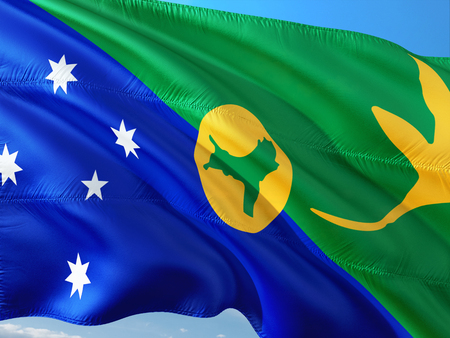 Flag of Christmas Island waving in the wind against deep blue sky. High quality fabric.の写真素材