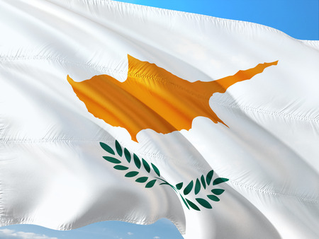Flag of Cyprus waving in the wind against deep blue sky. High quality fabric.の写真素材