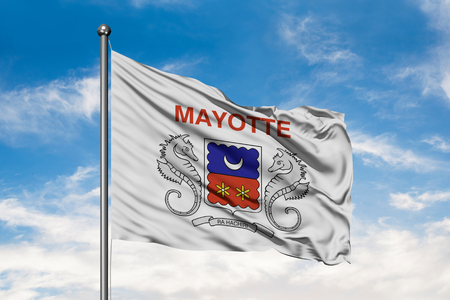 Flag of Mayotte waving in the wind against white cloudy blue sky.の写真素材
