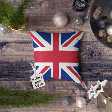 Happy New Year tag with United Kingdom flag on pillow. Christmas decoration concept on wooden table with lovely objects.の写真素材