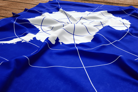 Flag of Antarctica on a wooden desk background. Silk flag top view.の写真素材