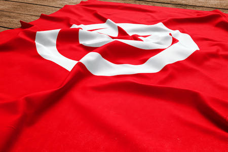 Flag of Tunisia on a wooden desk background. Silk Tunisian flag top view.の写真素材
