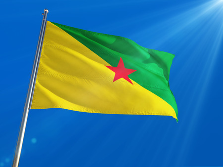 French Guiana National Flag Waving on pole against deep blue sky background. High Definitionの写真素材
