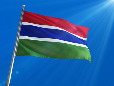Gambia National Flag Waving on pole against deep blue sky background. High Definitionの写真素材