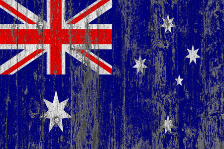 Flag of Australia painted on worn out wooden texture background.の写真素材